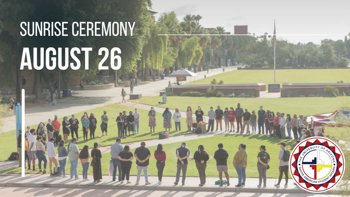 Students, staff, faculty, and community members standing in a circle