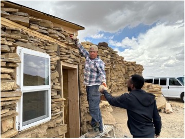 CIELO program participants helping Dr. Johnson build a stone passive solar green house; photo by Nina Sajovec, Haury Program